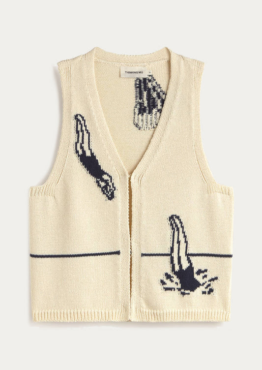 Cream-colored knit vest with black print designs on a white background