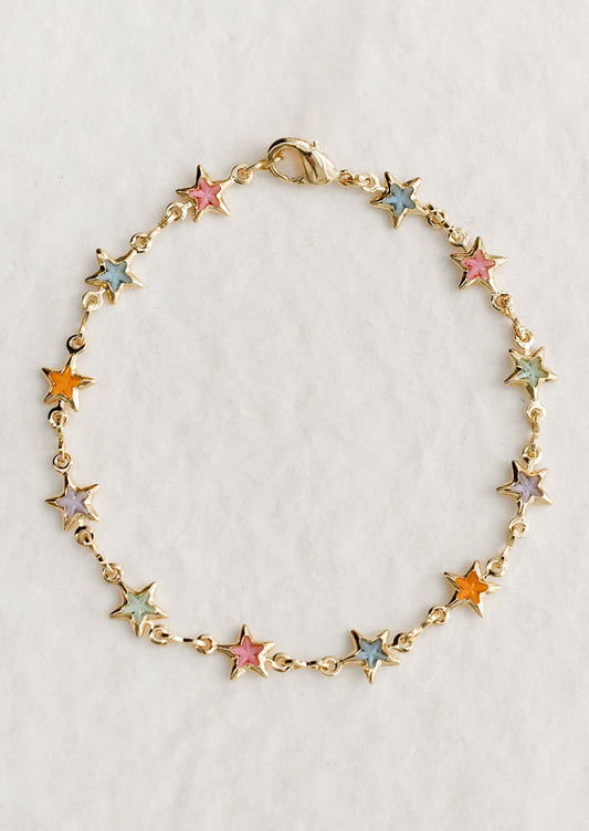 A gold bracelet with pastel colored glass star stations throughout.