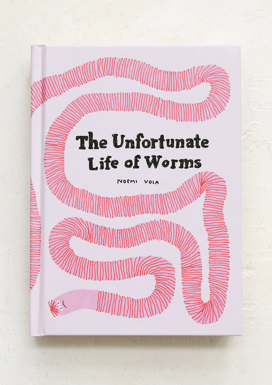 Book titled 'The Unfortunate Life of Worms' with pink worm illustration on a white background