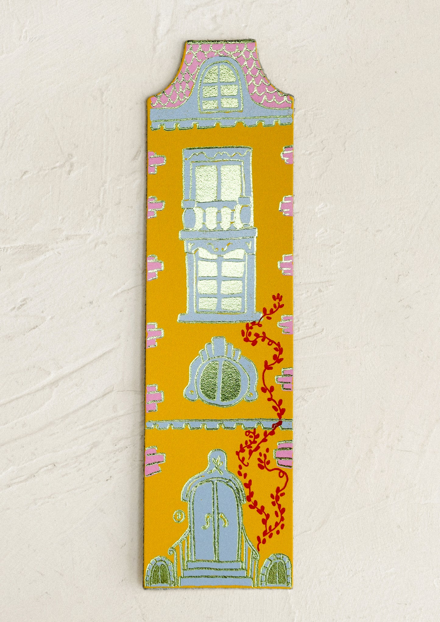 Decorative doll-house shaped bookmark with architectural illustrations on a beige background