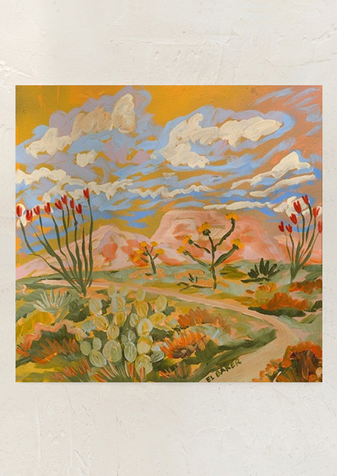 Painting of a desert landscape with cacti and flowers on a white wall.