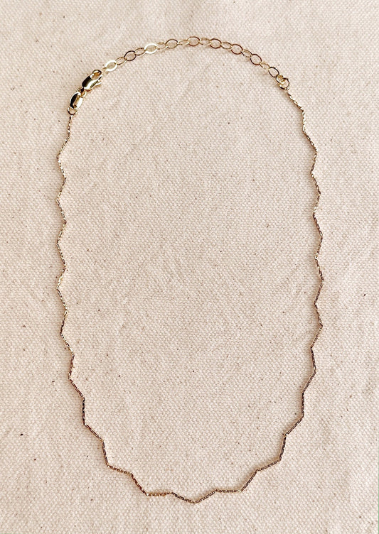 A zig zag gold choker.