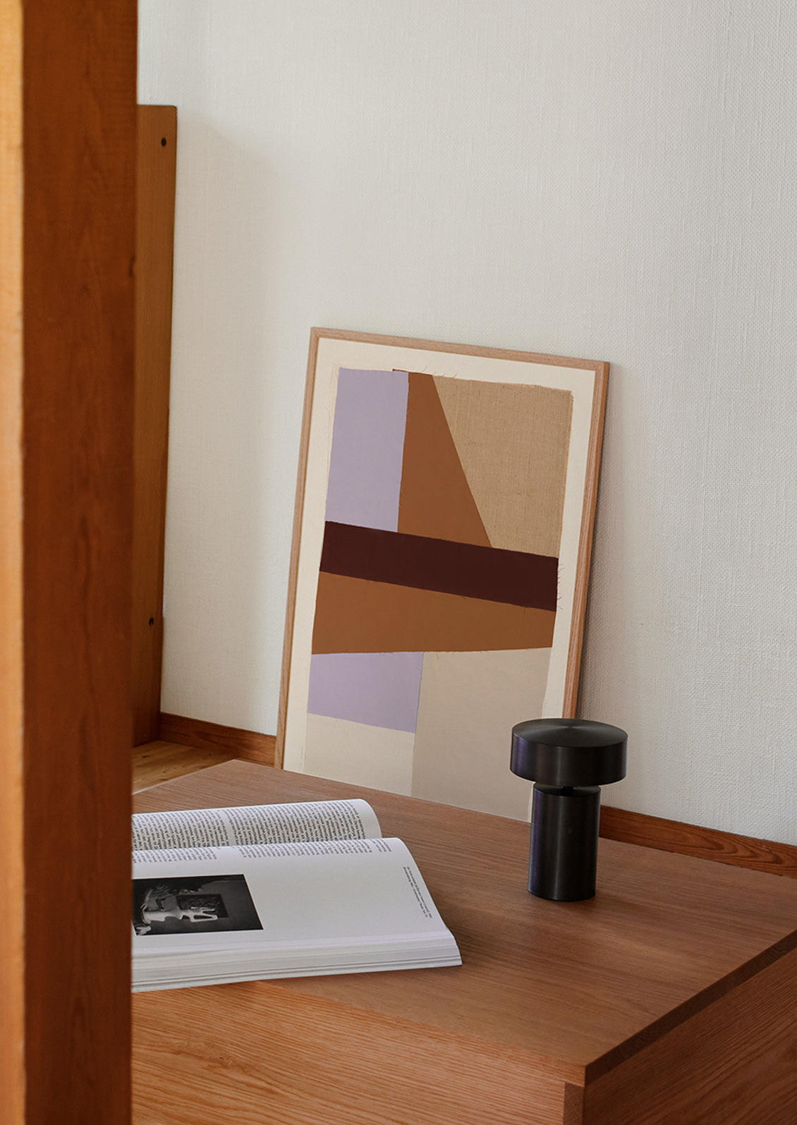 A framed photographic art print leaning against a wall.