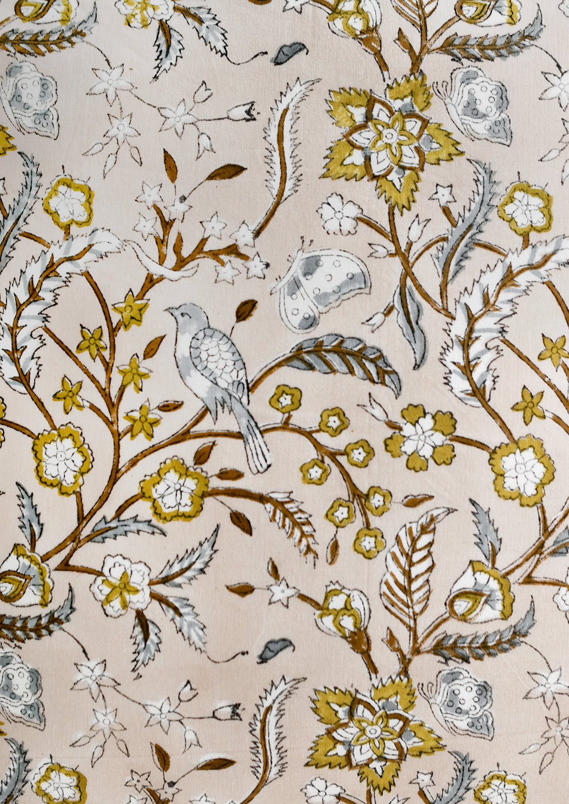 A block printed fabric with birds, flowers and butterflies.