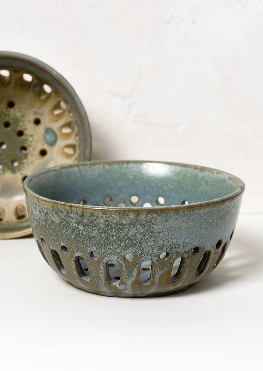 Ceramic berry colanders in mottled glazes.