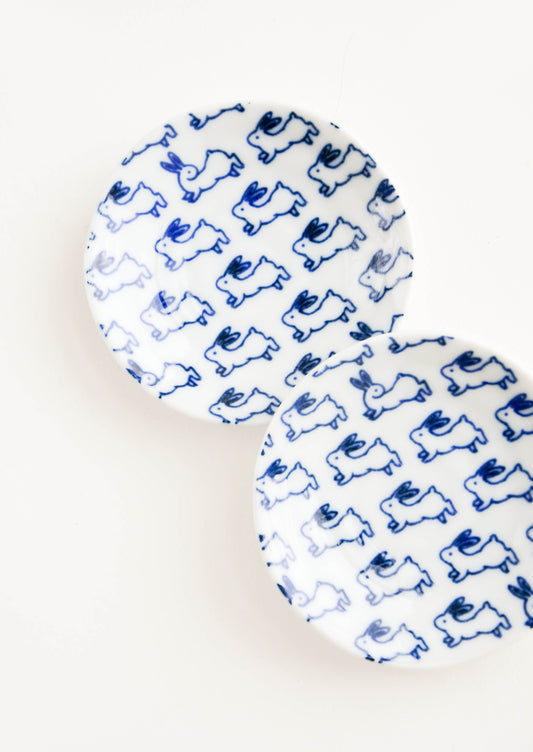 Aerial view of ceramic plate in white with allover bunny print in blue