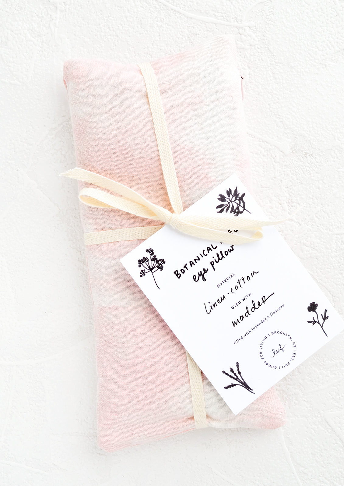 A naturally dyed relaxation eye pillow in pale pink color dyed using madder.