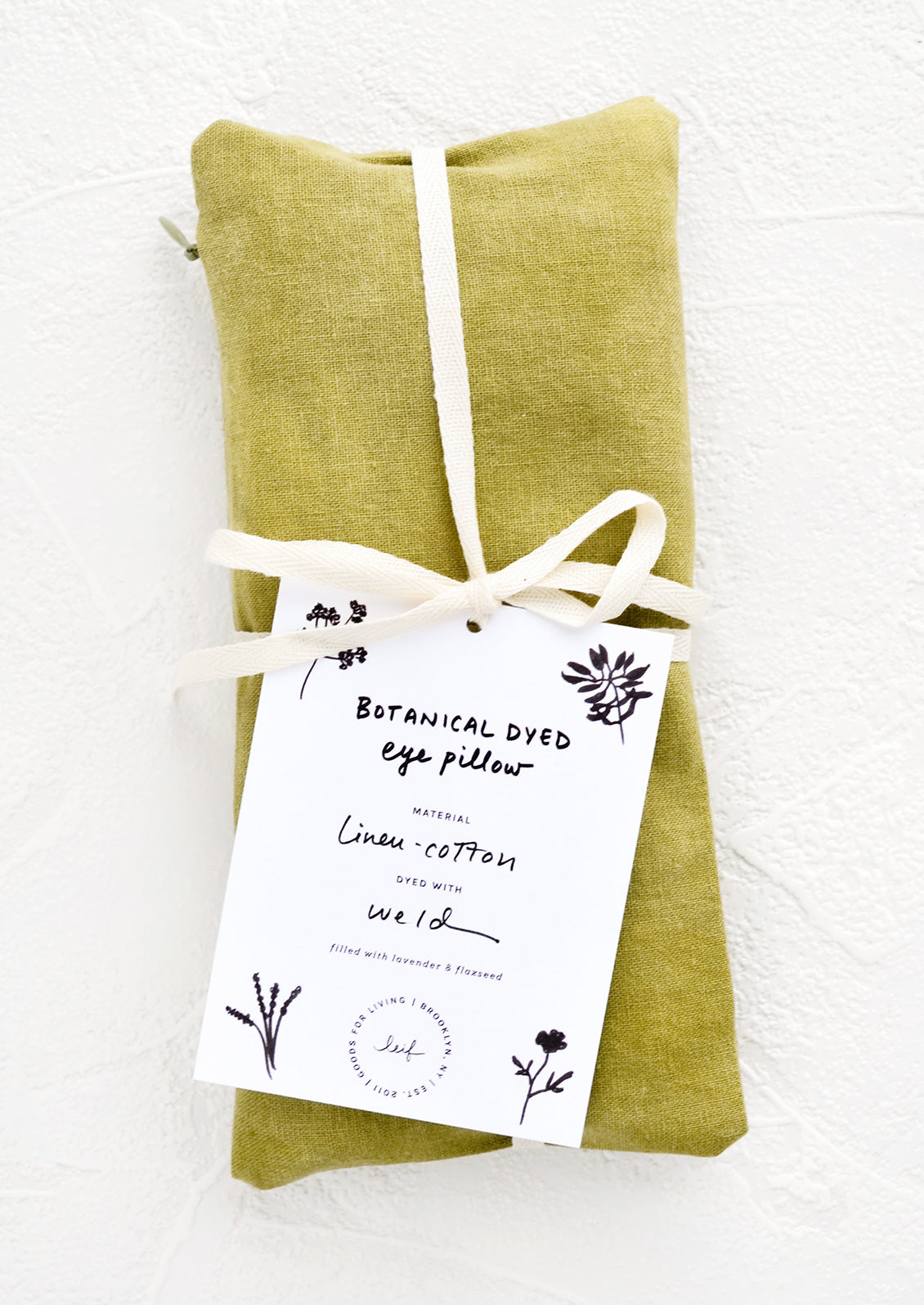 A naturally dyed relaxation eye pillow in olive green color.