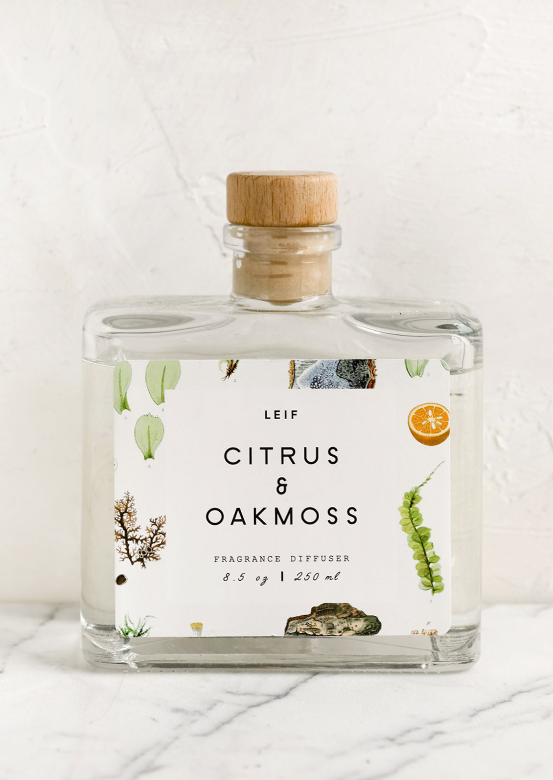 A citrus and oakmoss scented reed diffuser with glass bottle.