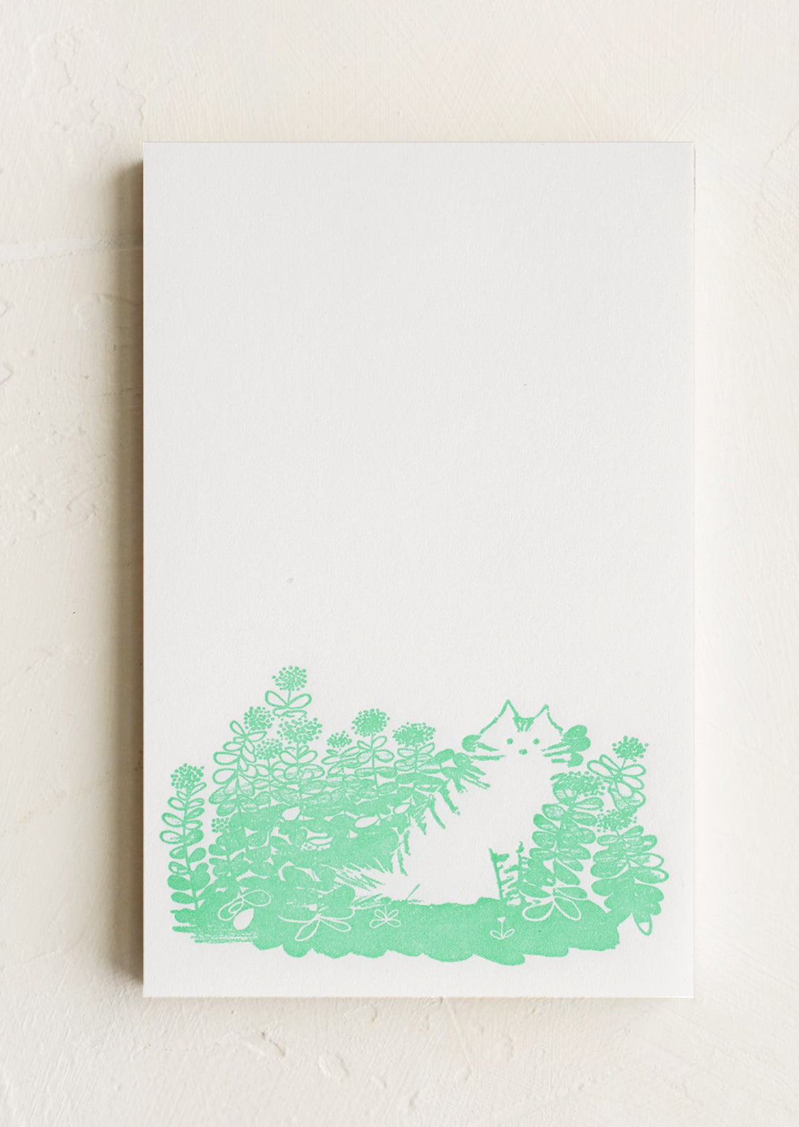 A letterpress printed notepad with cat design at bottom.