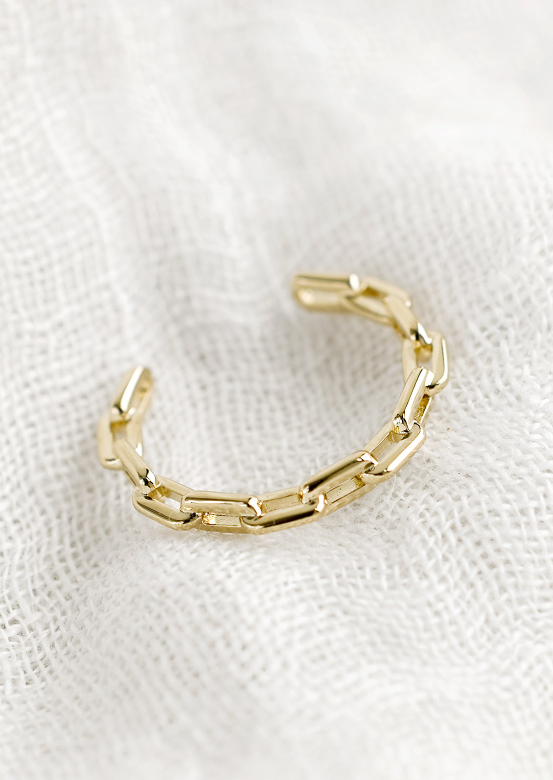 An open ended ring with chainlink style band.
