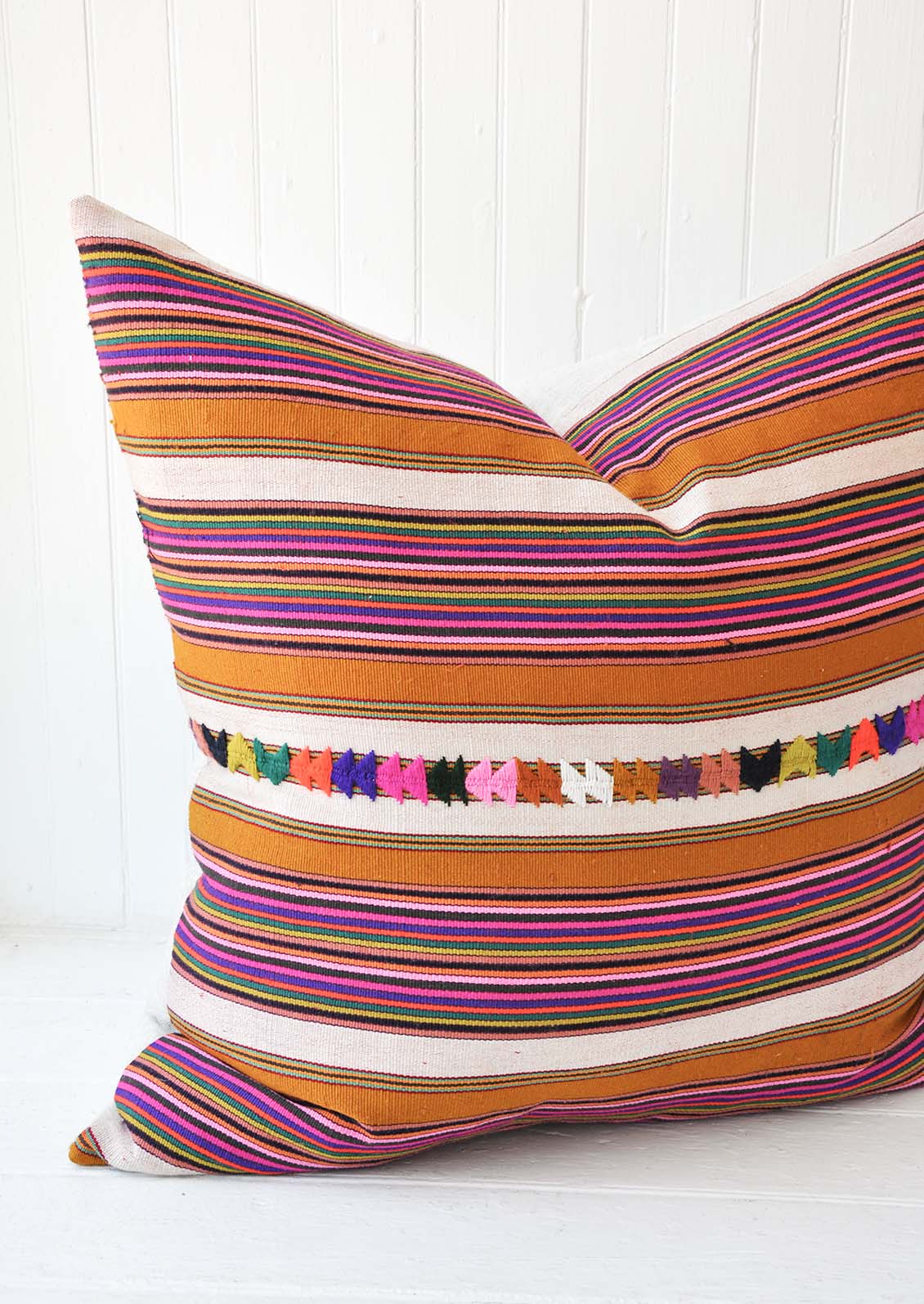 A multi-colored stripe pillow.