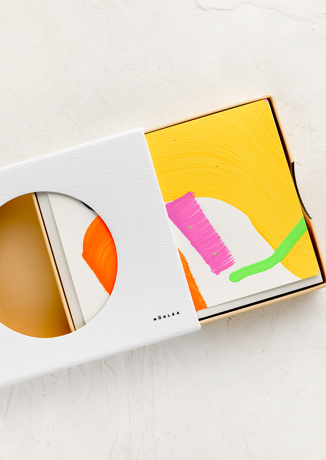A set of saturated color abstract painted greeting cards in a box.