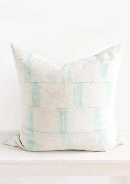 Square throw pillow in faded vintage fabric with vertical line print