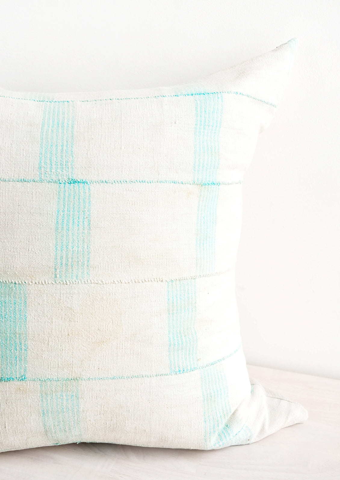Square throw pillow in faded vintage fabric with vertical line print