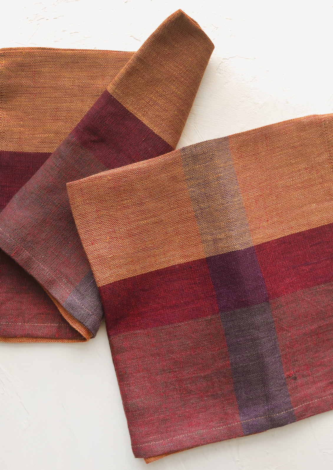 A pair of color overlay linen napkins.