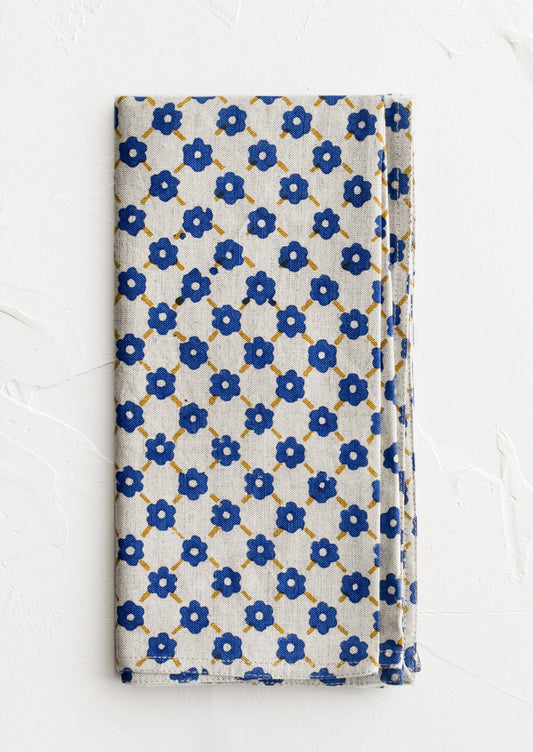A block printed napkin with blue and yellow floral print.