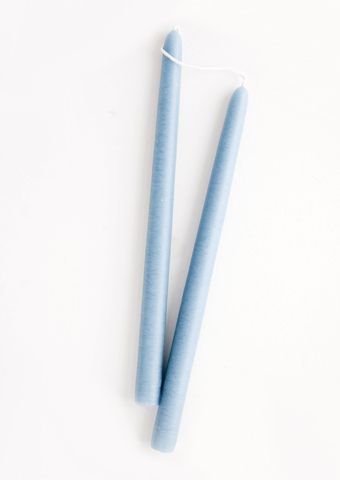 Pair of taper candles in denim blue