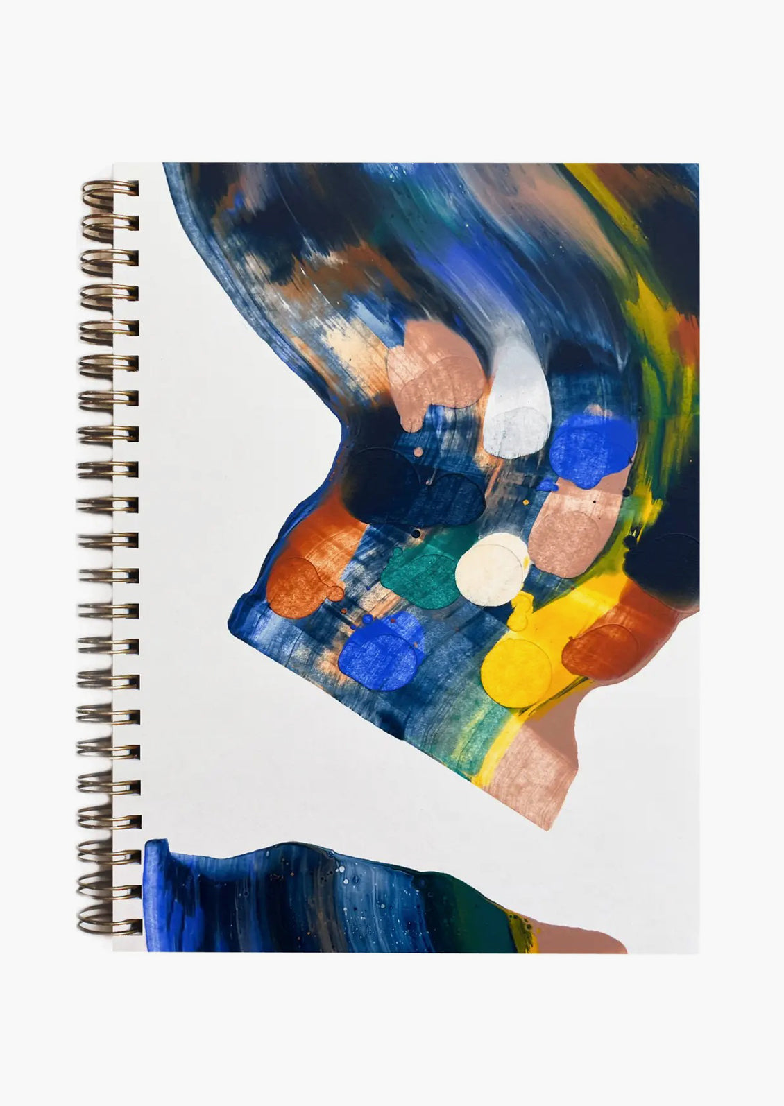 A spiral notebook with cover painted in earth toned paint swirls