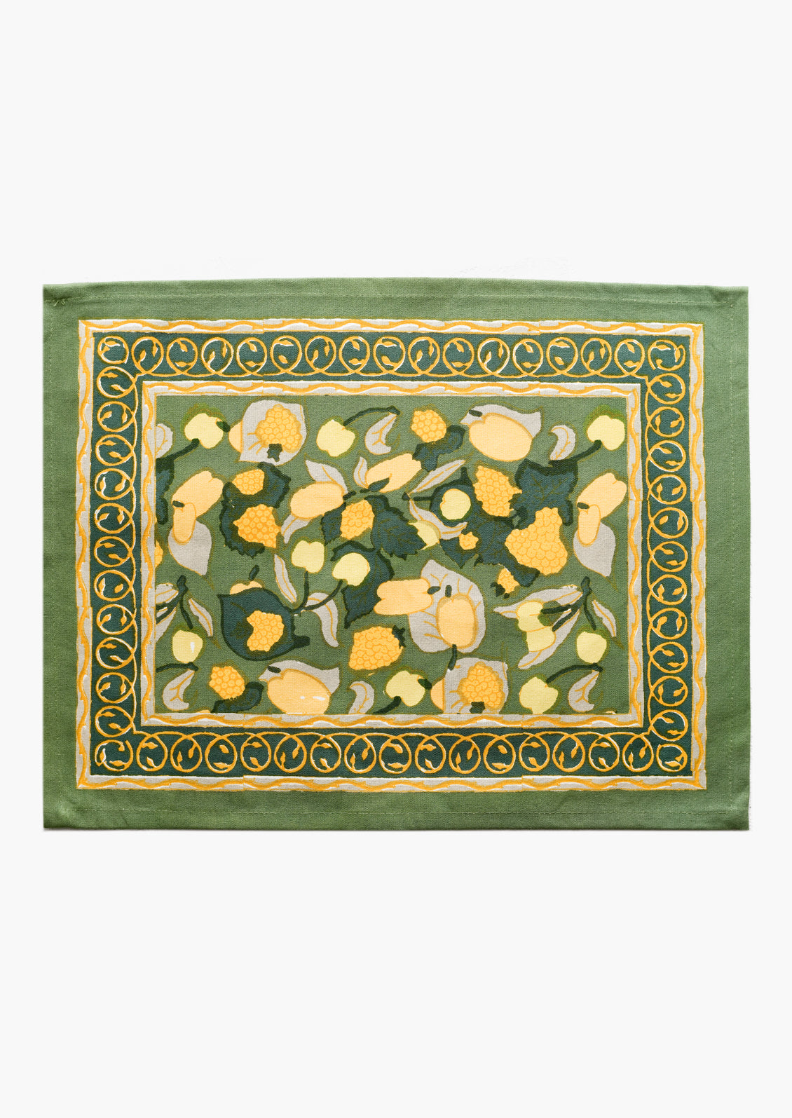A block printed placemat in green and yellow fruit print.