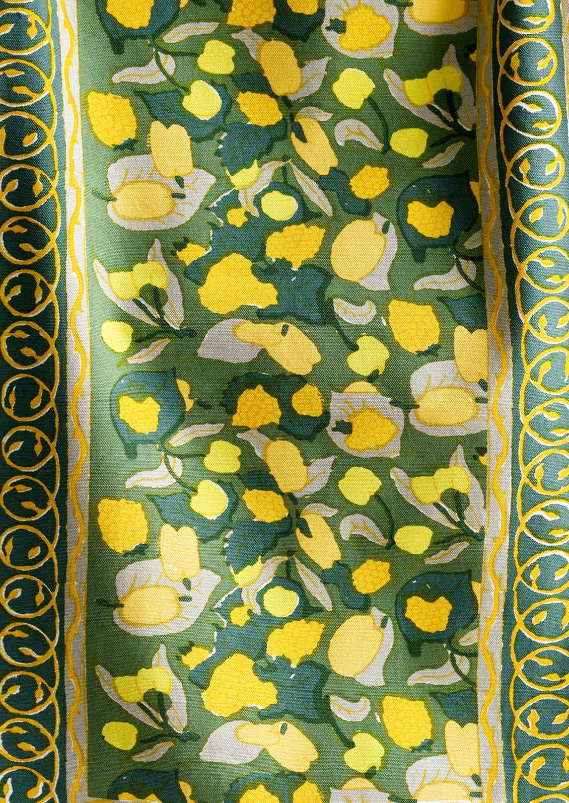 A block printed table runner in green and yellow print.