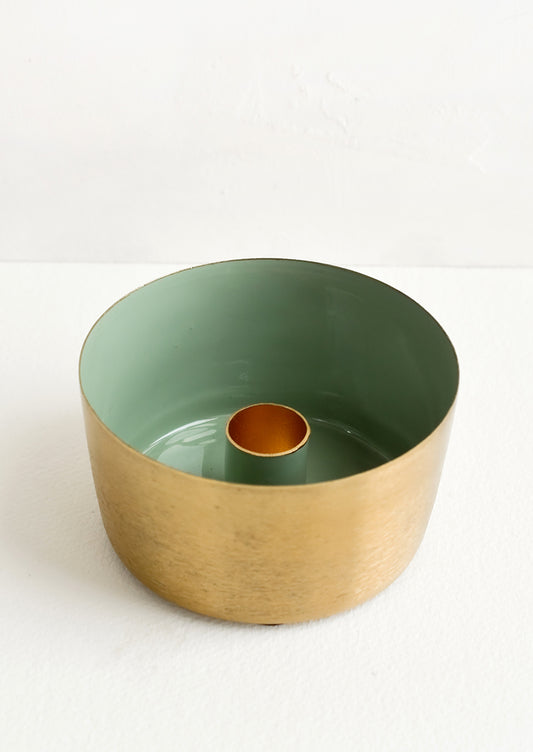 A round brass taper holder with high walls and green enamel lining.