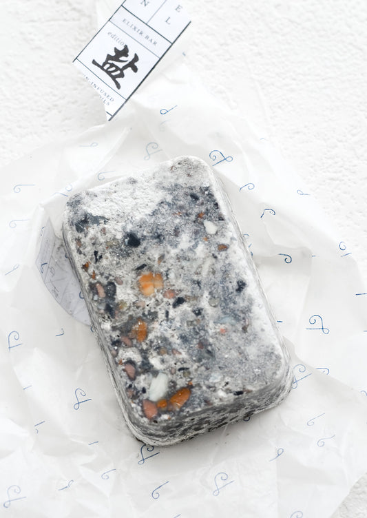 A bar of soap in grey speckled texture.