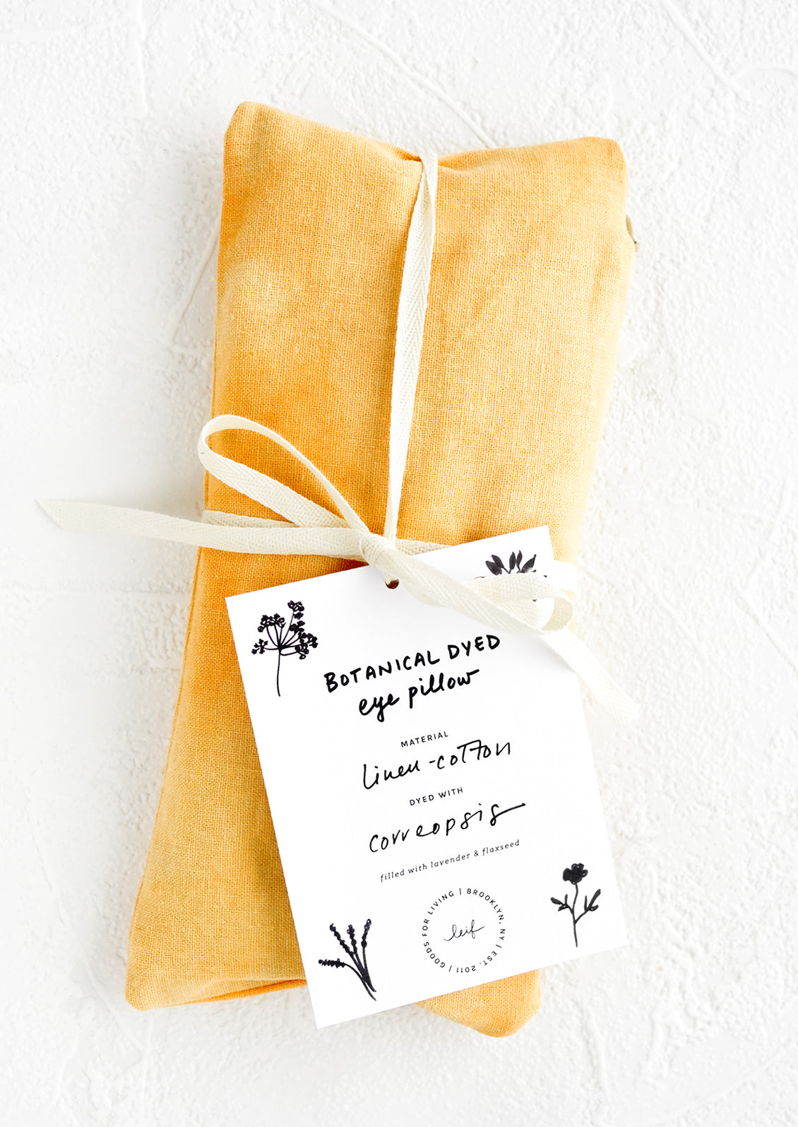 A naturally dyed relaxation eye pillow in orange colored natural dye.
