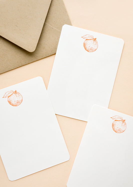 Set of flat white notecards with single orange printed at top
