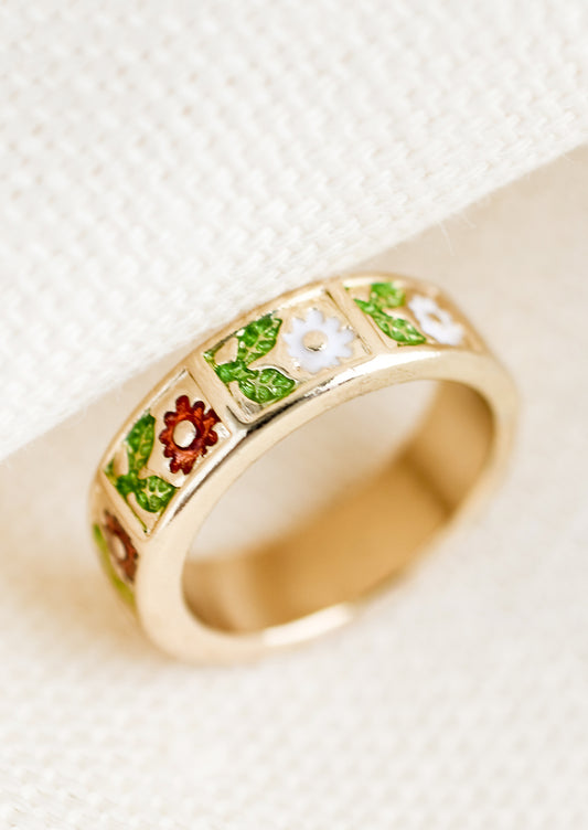 A gold ring with enamel floral design.