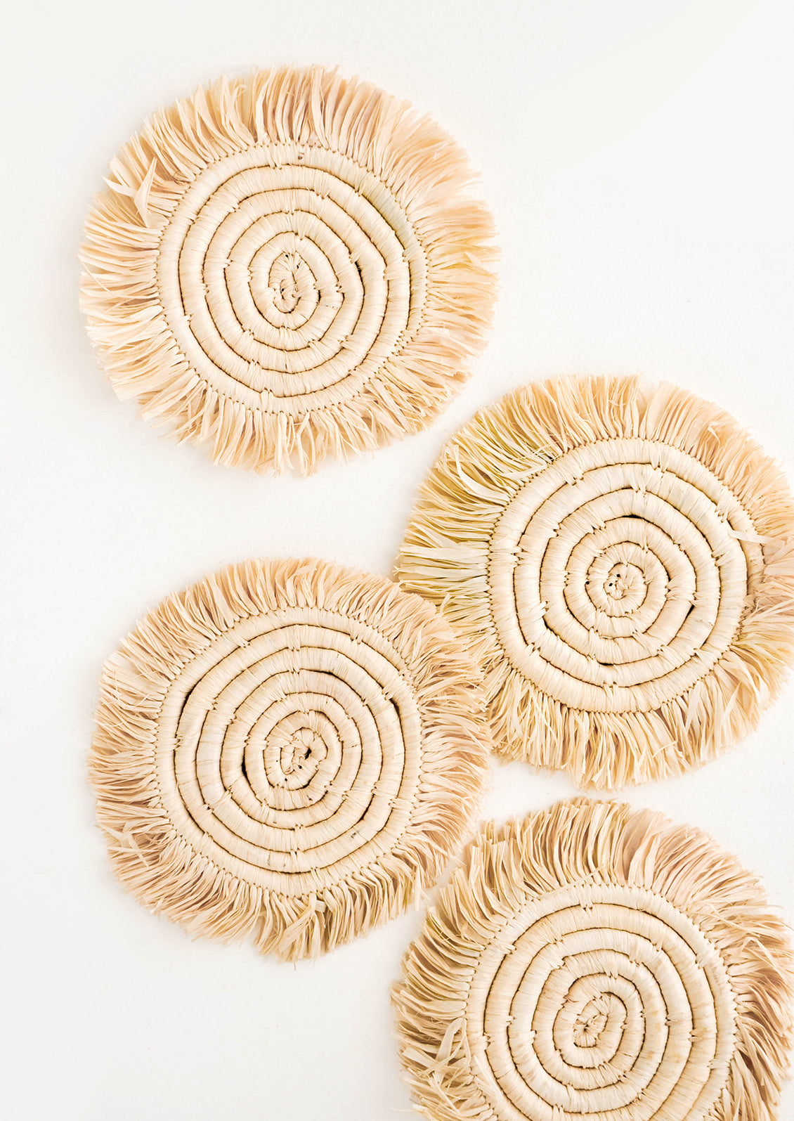 Set of 4 Circular Raffia Coasters with Fringed Trim in Natural