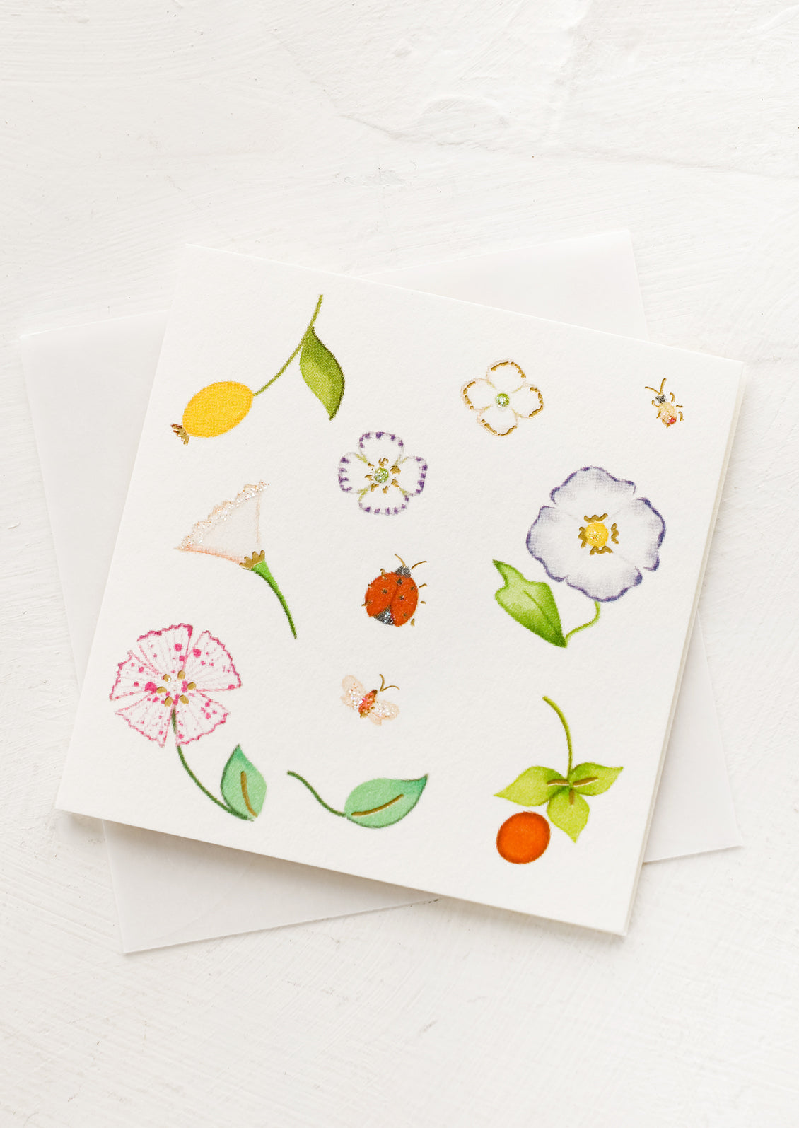 A small gift enclosure card with botanical illustration.