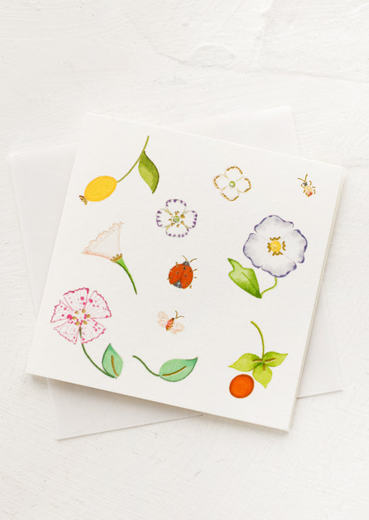 A small gift enclosure card with botanical illustration.