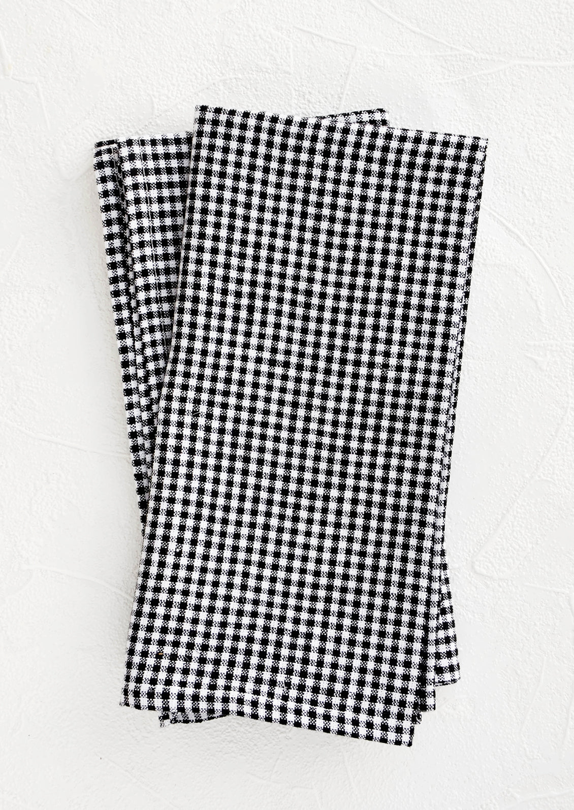 Pair of fabric dinner napkins in black and white gingham pattern