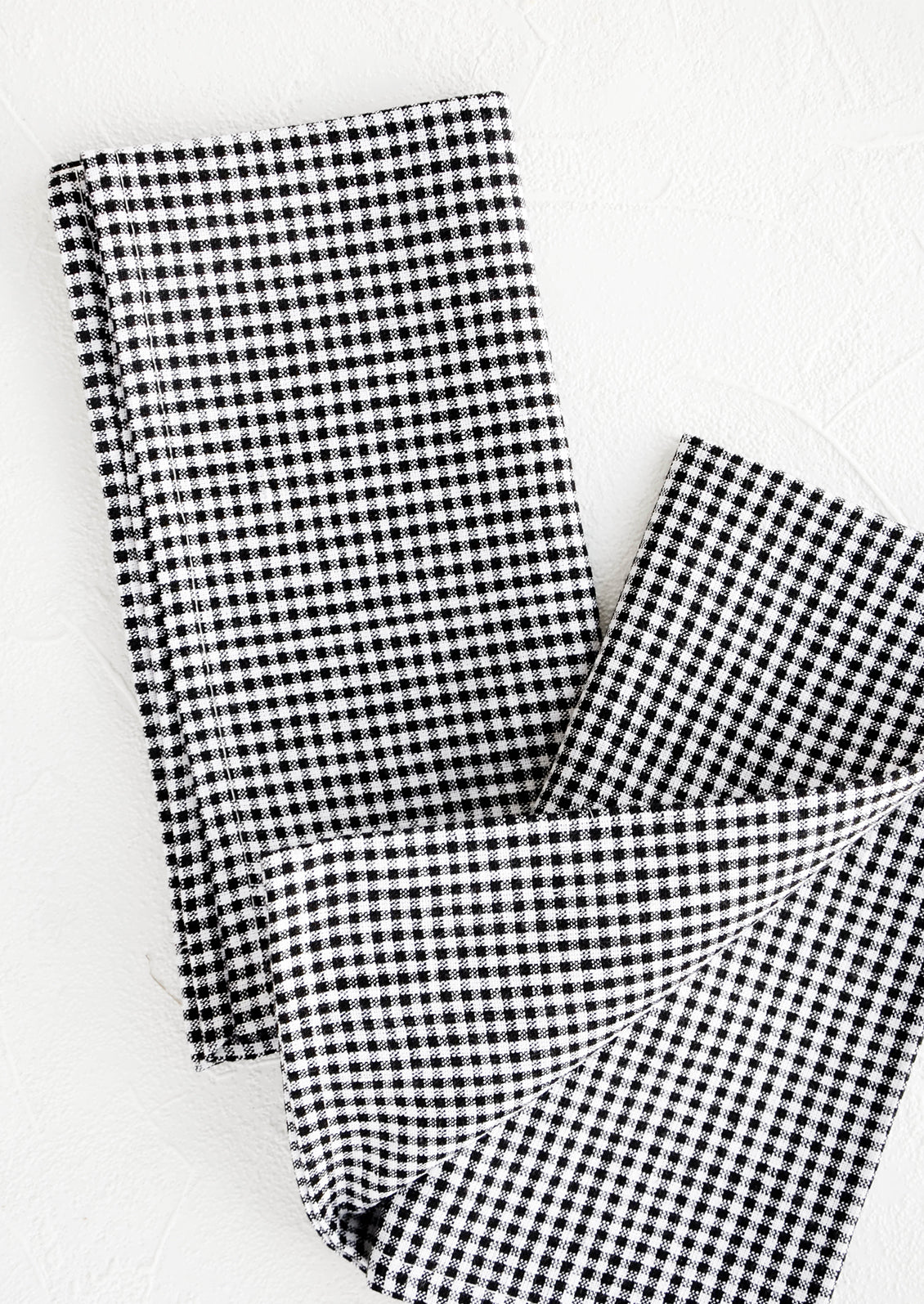 Pair of fabric dinner napkins in black and white gingham pattern