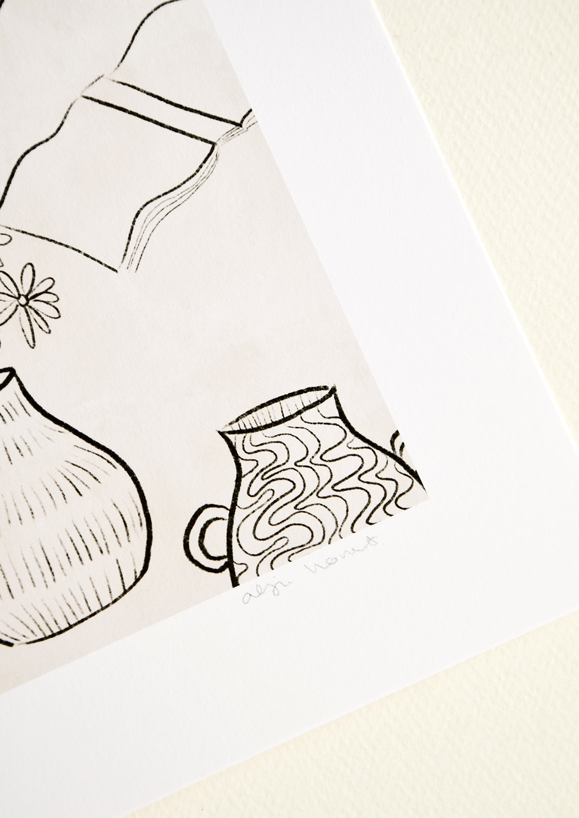 Artist's signature in pencil on corner of art print.