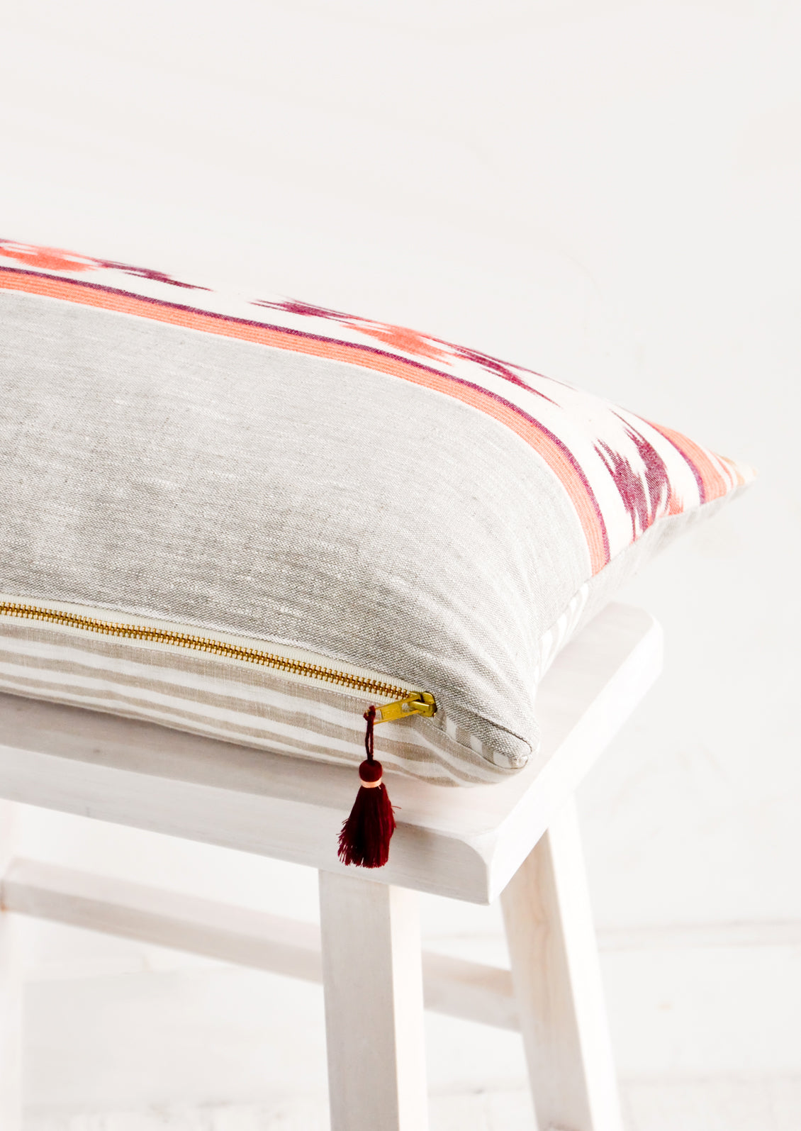 Brass metal zip closure at bottom with decorative tassel detail