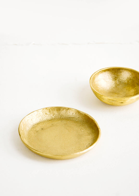 Small brass bowl and plate, both showing an organic, textured finish