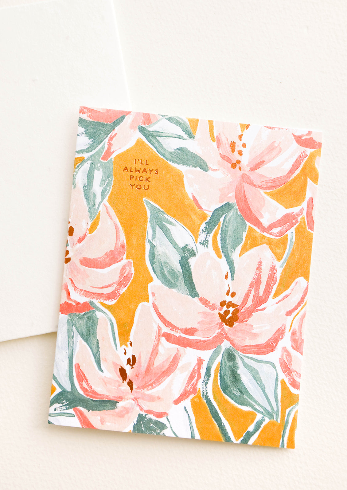 Greeting card with painterly floral pattern and copper text "I'll Always Pick You", paired with seed paper envelope