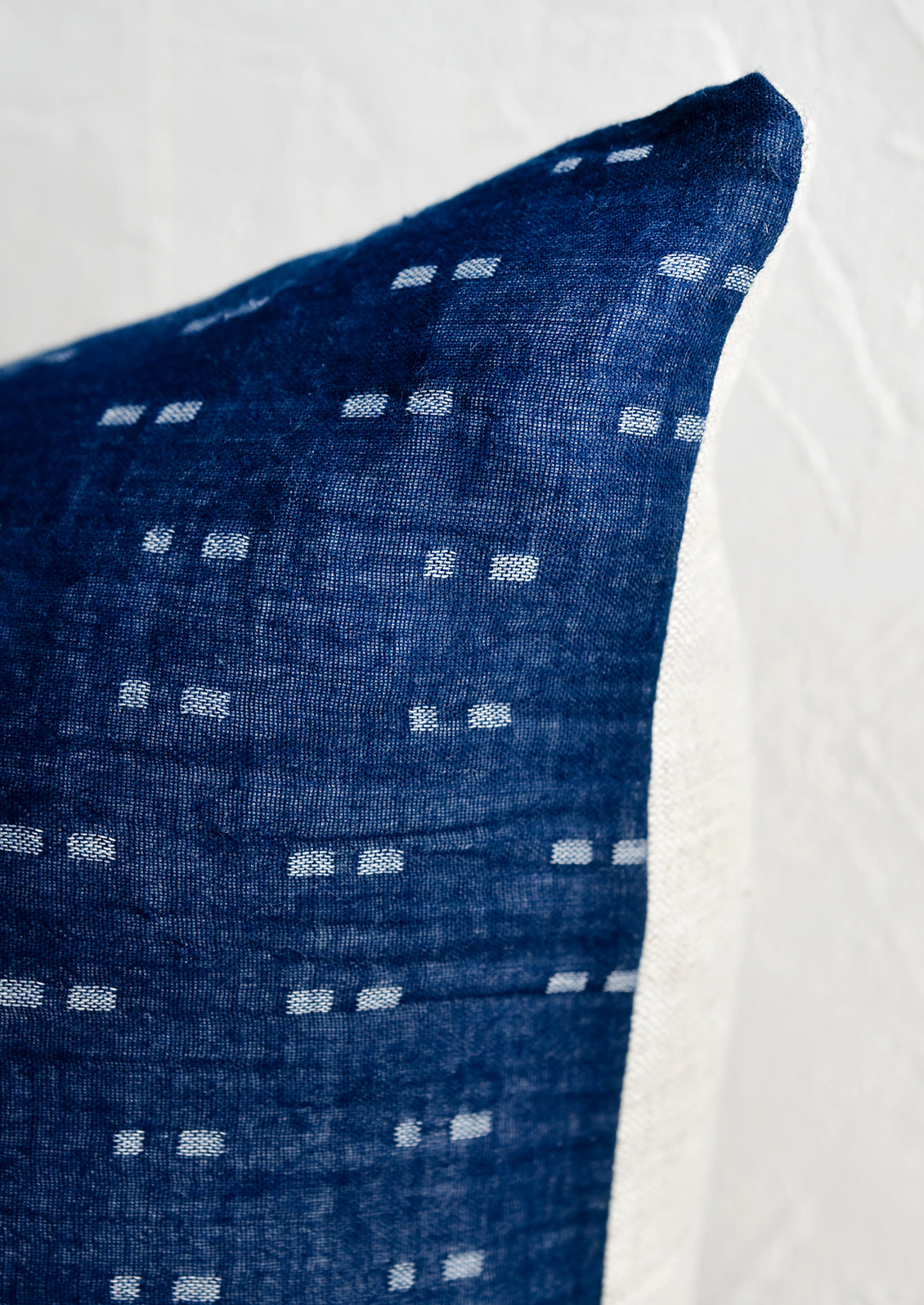 Woven indigo fabric with dash pattern woven in.