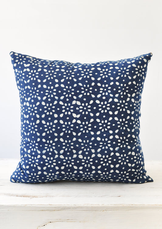 A square indigo and white block printed pillow.