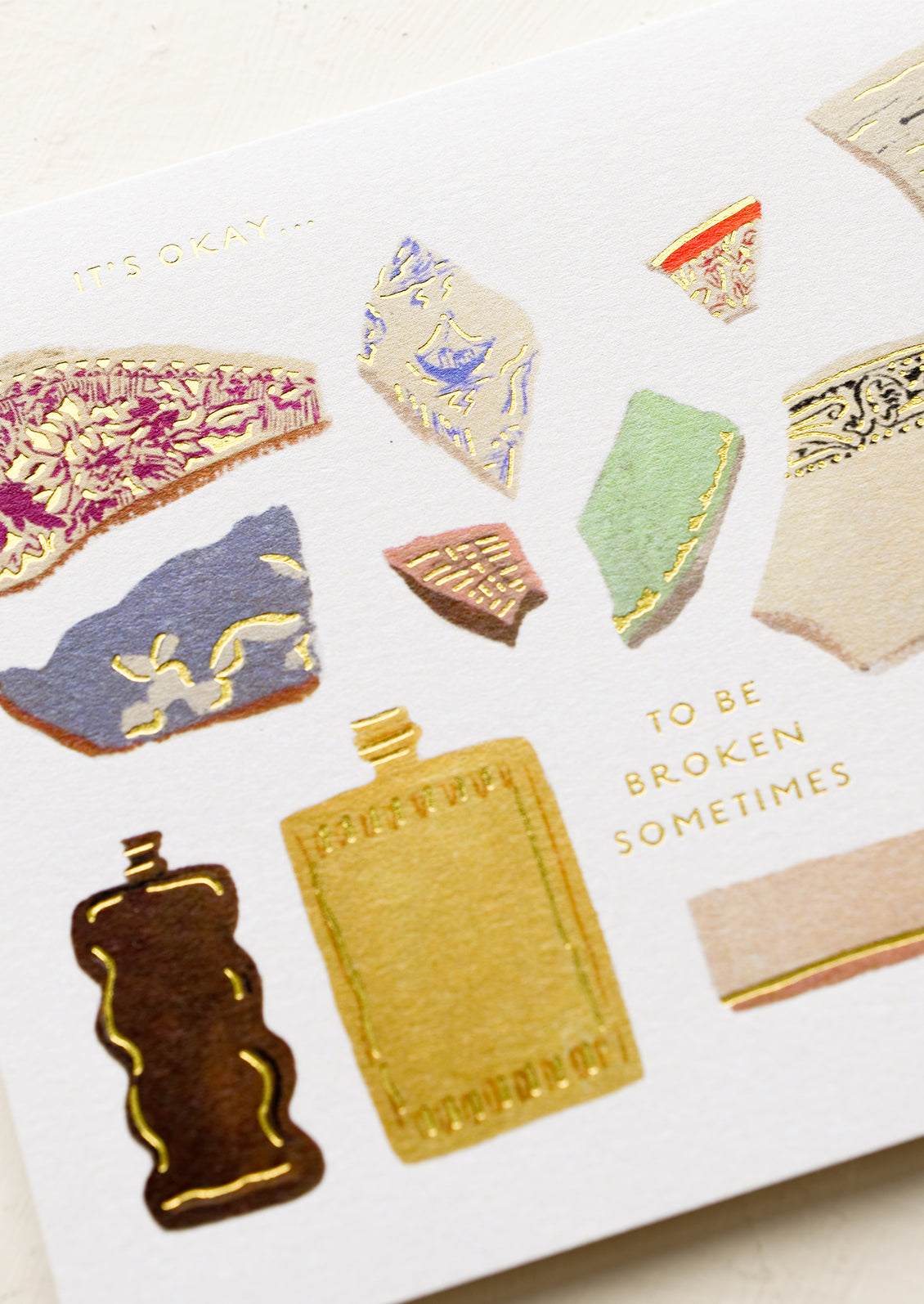 A card with illustration of broken shards of pottery, text reads "It's okay to be broken sometimes".