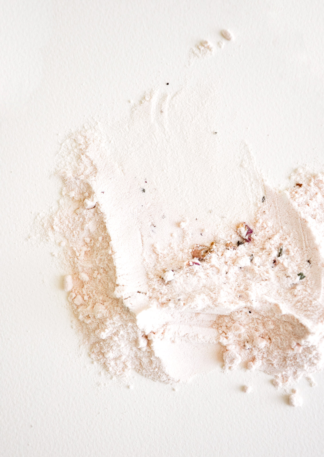 Milk bath powder with rose petals.