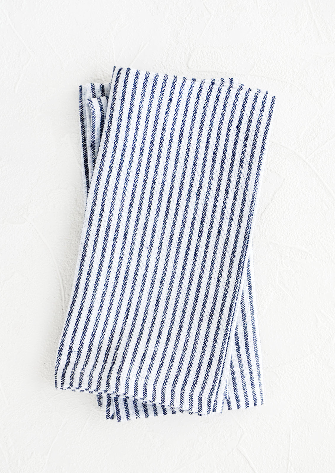 Pair of fabric dinner napkins in navy blue and white stripes