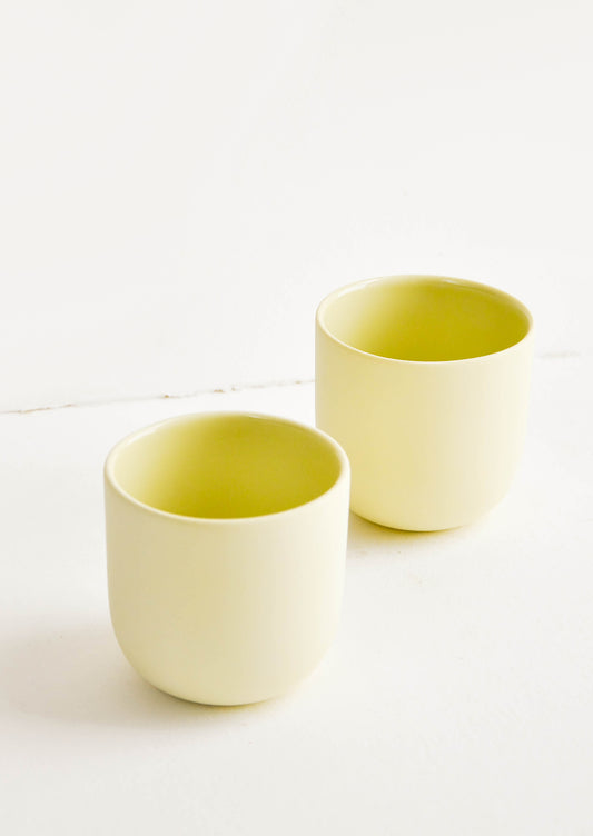 Two yellow matte porcelain short tumblers.