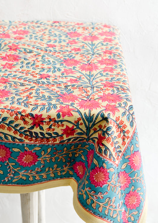 A vibrantly colored block printed tablecloth with floral print.