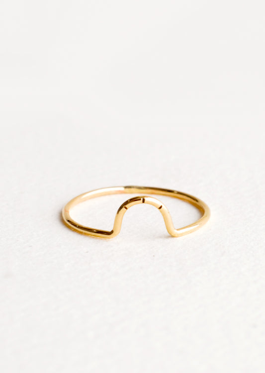 Thin gold ring showcasing small arced feature with three etched lines. 