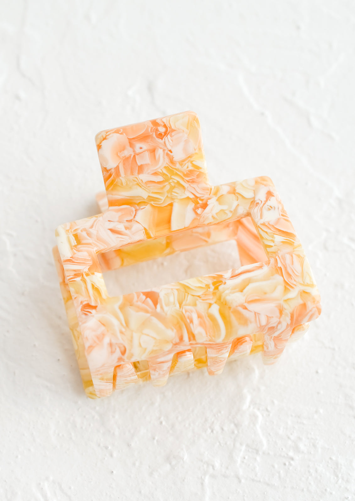 A marbled hair clip in orange marble.
