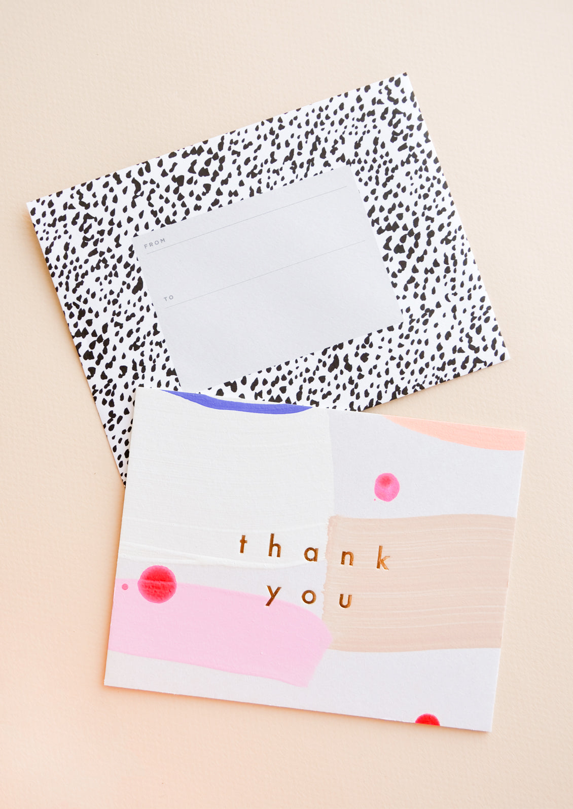 Hand painted card in colorful abstract pattern with gold foil "Thank you" text, paired with black and white printed envelope