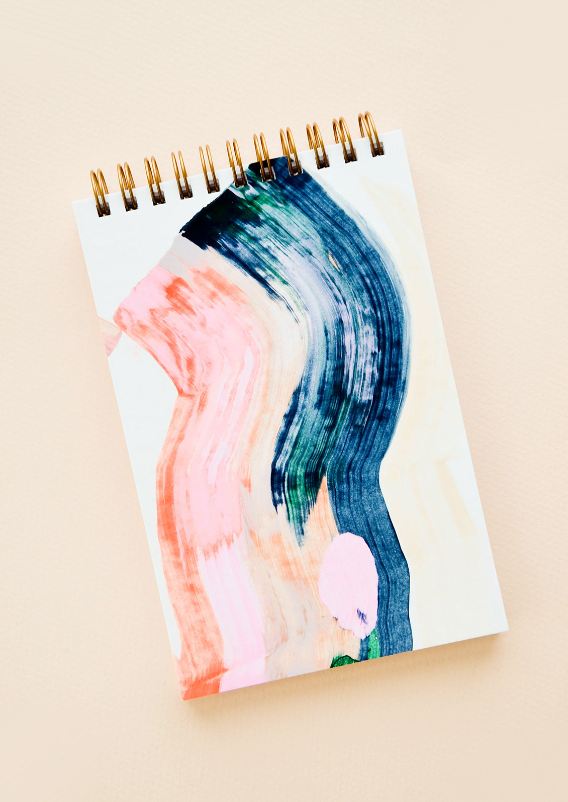 Cover of a spiral notebook, decorated with painted colors pink and blue.
